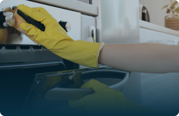 person cleaning a stove